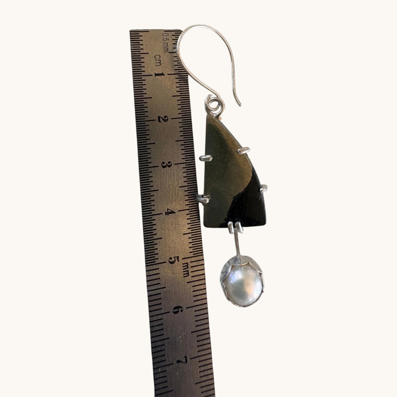 Paarisha Jewelry sterling silver earring featuring a triangular obsidian stone and a dangling white pearl